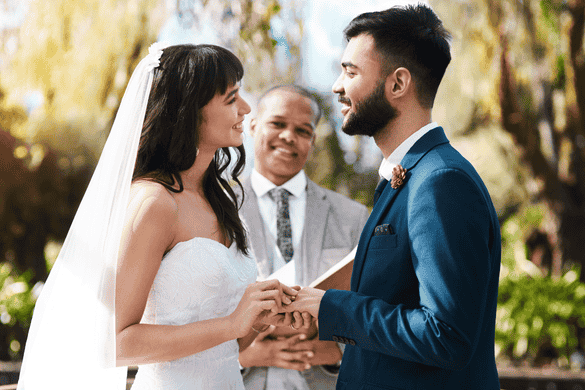 a couple smiling during vows at a wedding